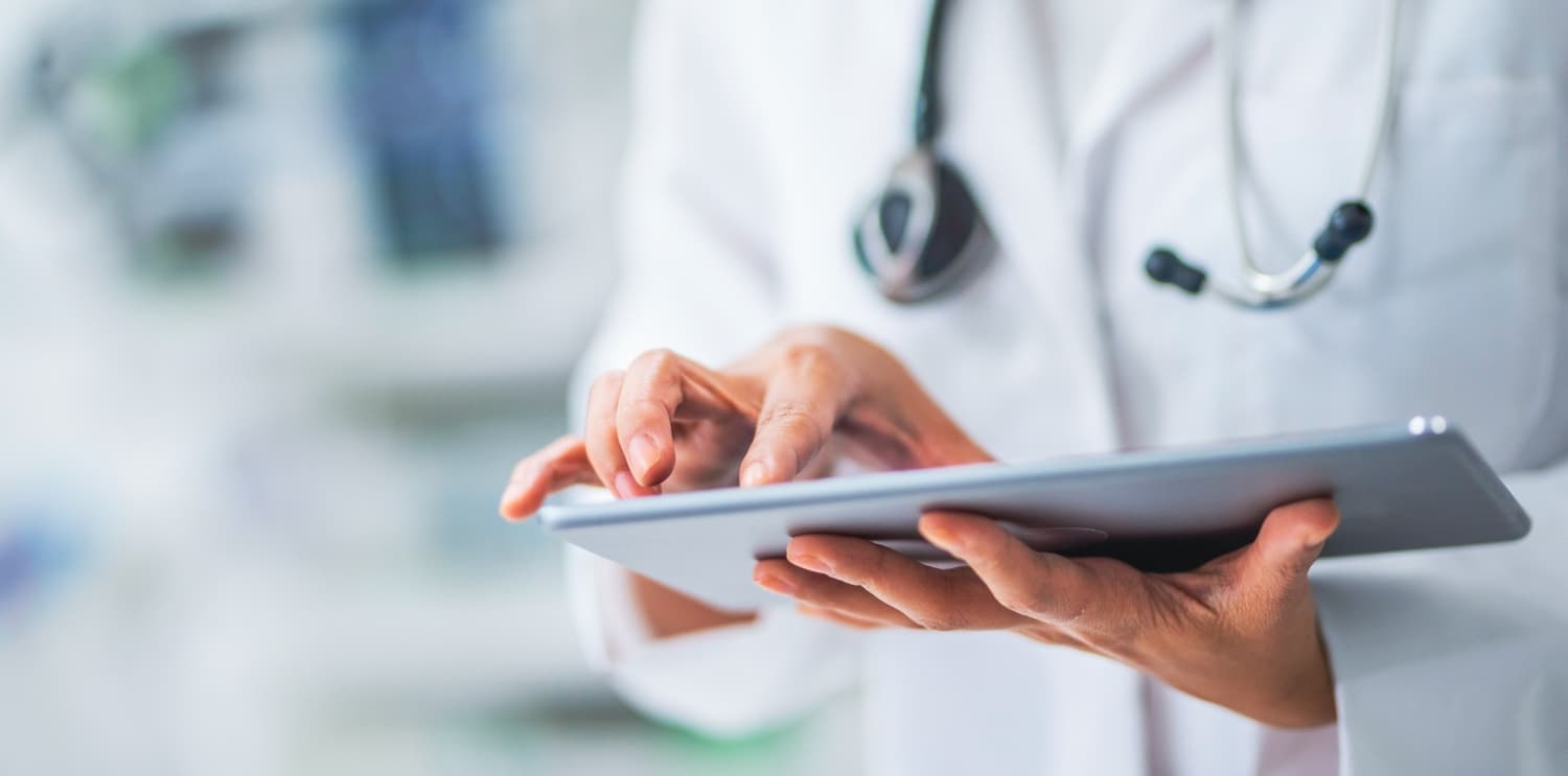 Doctor using appointment scheduling on iPad