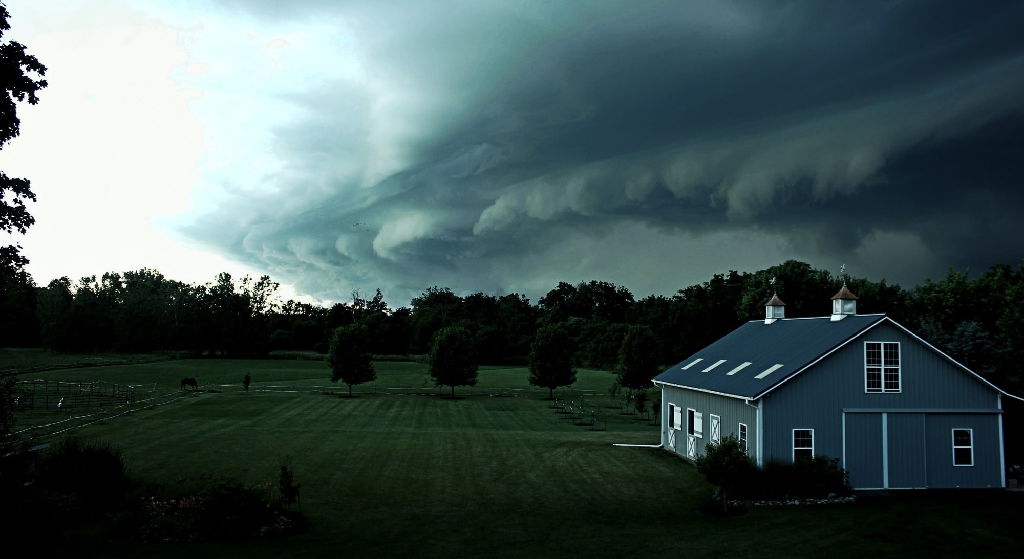Stormy weather above farm house during emergency alerts