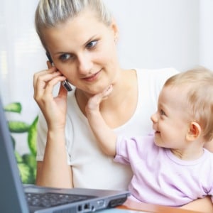 Woman with baby calling help desk